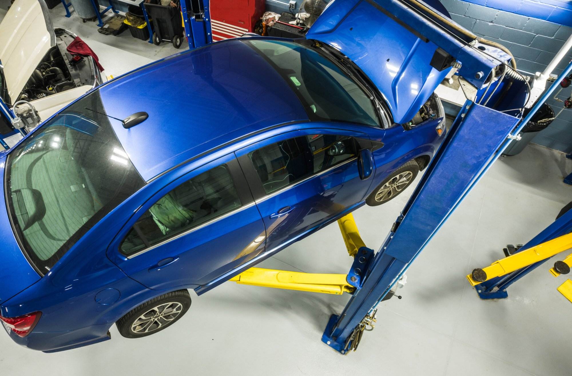Blue Car on lift getting repairs